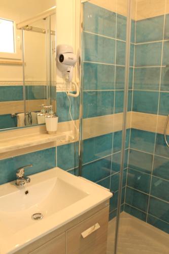 a bathroom with a shower and a sink and a mirror at B&B AcquaDolce in Cala Gonone