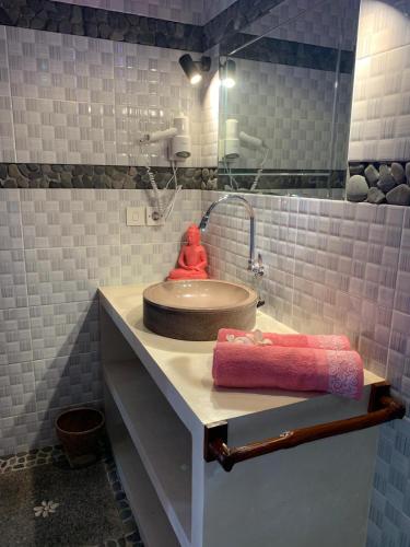 a bathroom with a sink and a red towel on a counter at Villa Anjing in Nusa Dua