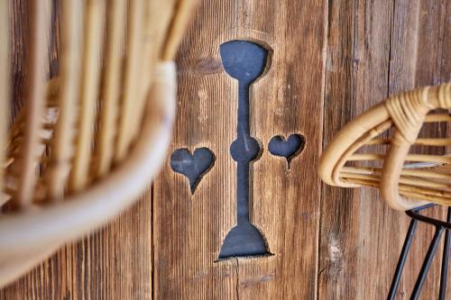 a spoon on a wooden table with hearts on it at City Suites Murnau in Murnau am Staffelsee