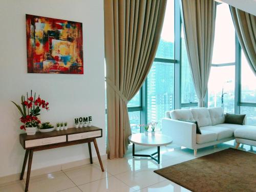 a living room with a couch and a table at Evo Bangi Duplex Homestay D' Imahzzz - 3BR or 2BR in Bangi
