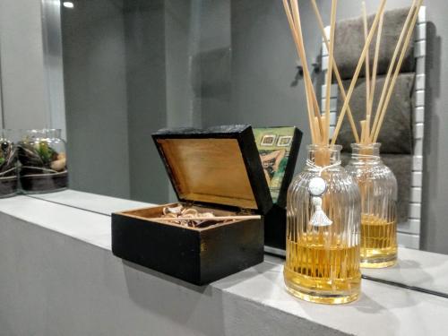 a table with two vases and a box on it at Rumi Rooms in Como