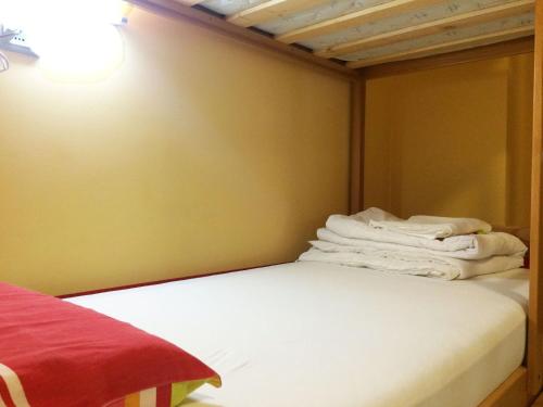 a room with a bed with white towels on it at Europa Hostel Portorož in Portorož