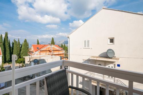 a balcony with a view of a white building at Villa Voinic 3 in Cavtat