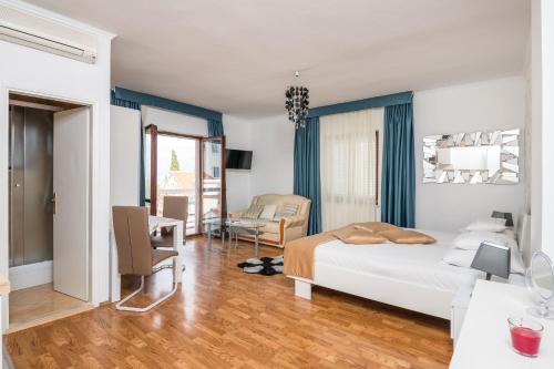 a bedroom with a bed and a living room at Villa Voinic 3 in Cavtat