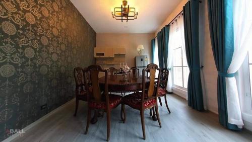 a dining room with a table and chairs and a window at Villa PaSon in Khao Kho