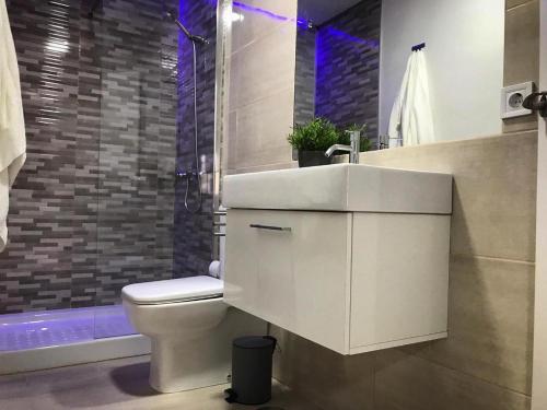 a bathroom with a sink and a toilet and a shower at Arrebol Vegueta in Las Palmas de Gran Canaria