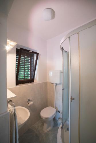 a bathroom with a toilet and a sink at Apartmani Mia in Palit
