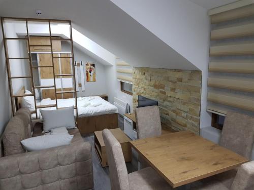 a living room with a couch and a fireplace at Milmari, Resort, Premier Apartman A52 & Parking garage FREE in Kopaonik