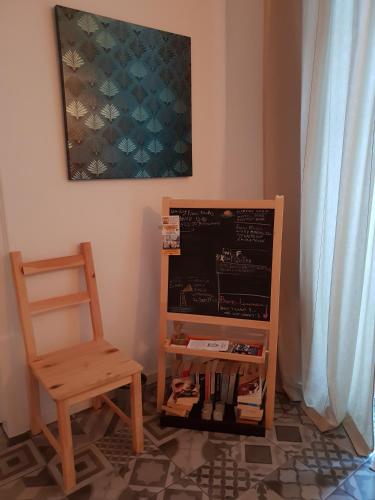 a chair sitting next to a chalkboard next to a table at Old Charming House Faro in Faro