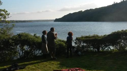 a group of people standing next to a body of water at Broomhill Barns in Minwear
