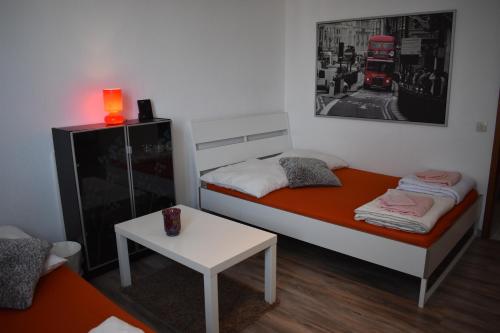 a small room with a bed and a table at FeWo Köln in Cologne