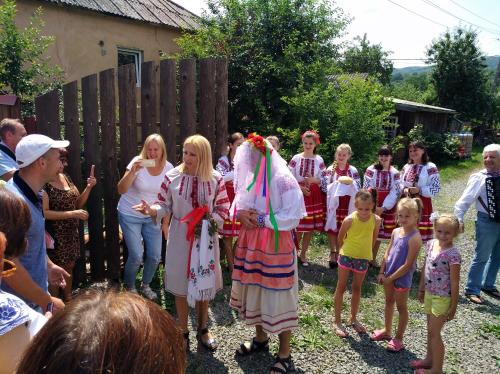 a group of children standing around a group of people at Bed&Bike Dobra Nuć in Dubrynychi