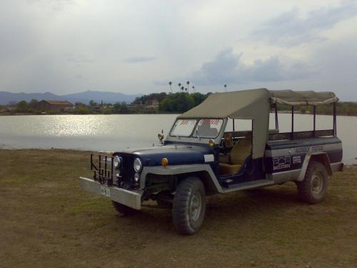 a blue jeep parked next to a body of water at Hotel Bella Vista in Huasca de Ocampo