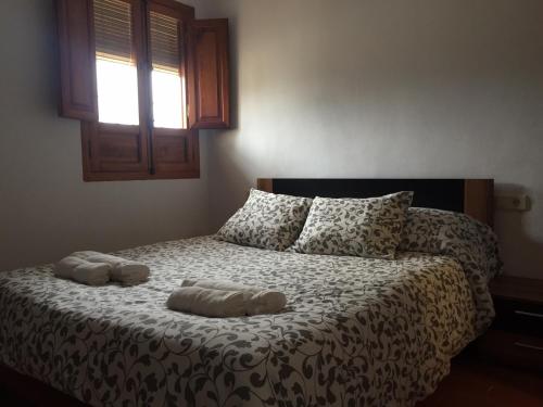 a bedroom with a bed with two towels on it at Finca Casa Grande in Tavernes de Valldigna