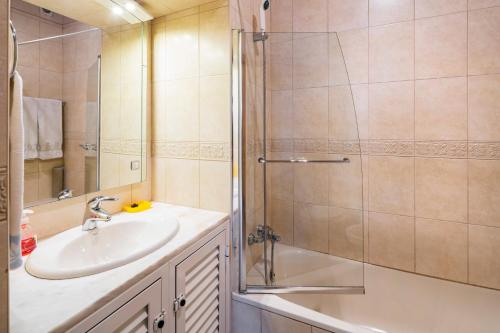 a bathroom with a sink and a shower at Casa da Vila in Albufeira