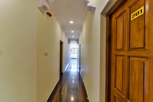 an empty hallway with a door and a long floor at Sonikas Holiday Homes (Studio) in Candolim