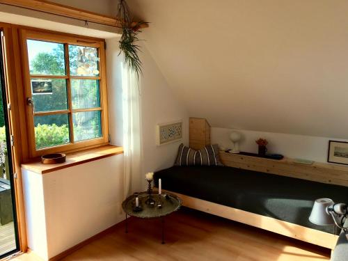 a bedroom with a bed and a window and a table at Ferienwohnung Wremer Straße in Wremen