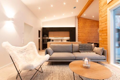 a living room with a couch and a table at Riverside luxury suites in Rovaniemi