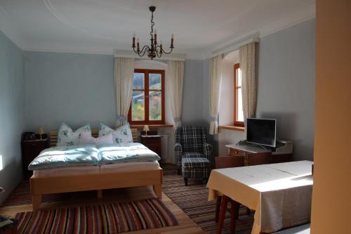 a bedroom with a bed and a desk with a computer at Stolznhof in Schönberg im Stubaital