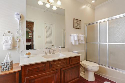 a bathroom with a sink and a toilet and a shower at Grenoble House in New Orleans