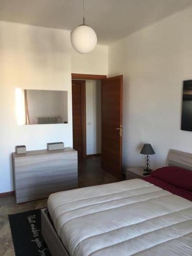 a bedroom with a bed and a dresser and a mirror at L'Alloggio Perfetto in Putignano