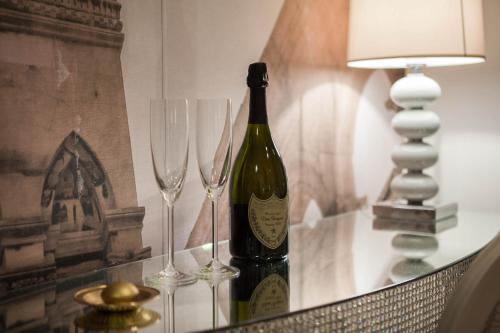 a bottle of wine and two wine glasses on a table at Guest House Imperial in Split