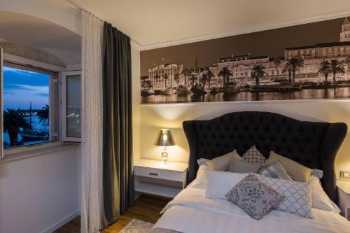 a bedroom with a large bed and a window at Guest House Imperial in Split