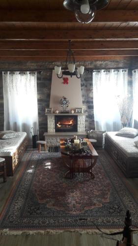 a living room with two beds and a fireplace at To Archontiko tis Nikis in Ioannina