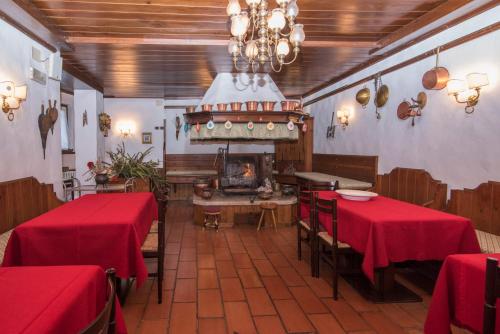 a restaurant with two tables and a fireplace in a room at Al Sole Hotel Ristorante dal 1870 in Pieve di Cadore
