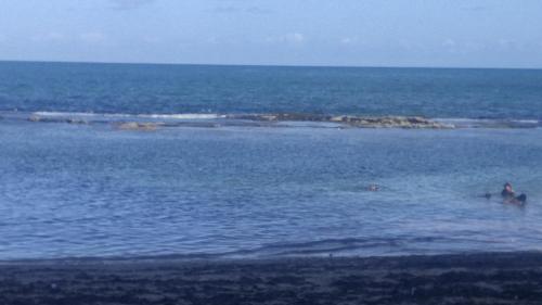 a person in the water near an island in the ocean at Pousada Nordestina in Recife