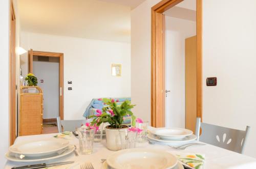 a dining room table with plates and dishes on it at Le Tartarughe Aparthotel in Letojanni