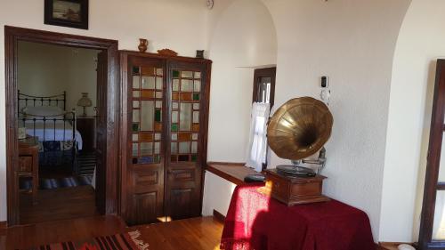 a room with a table with a fan in it at Archontiko Mansion Porteli Αρχοντικο Πορτελι in Makrinítsa