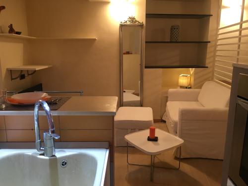 a kitchen and a living room with a sink at Ancient walls home in Genoa