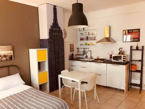 a bedroom with a bed and a kitchen with a table at Al Centro Città in Bergamo