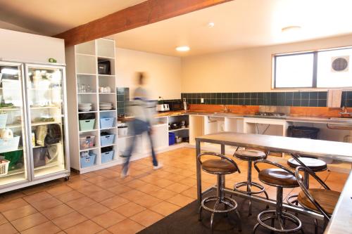 a person standing in a kitchen next to a counter at Dusky Lodge in Kaikoura