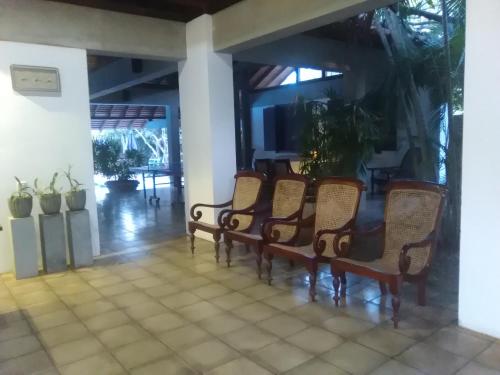 a group of chairs sitting in a room at Hotel Sunflower in Kataragama