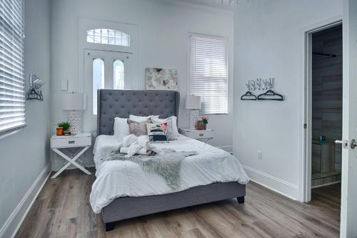 a bedroom with a bed with a stuffed animal on it at 4 BR - Sleeps 8! Best location next to Bourbon Street! in New Orleans