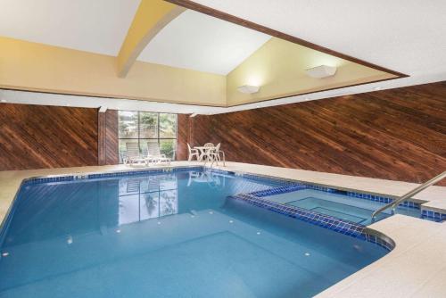 a large swimming pool in a house at Super 8 by Wyndham Wausau in Wausau