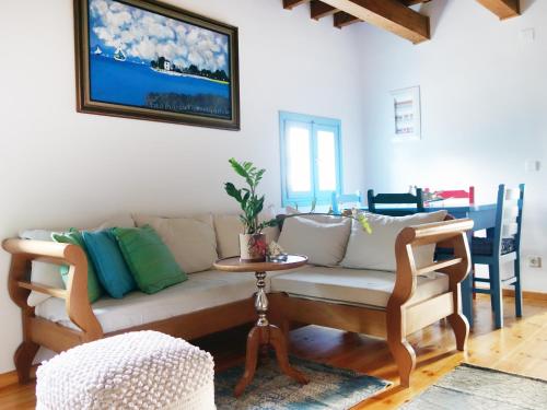 a living room with a couch and a table at Villa Antonia in Almirida