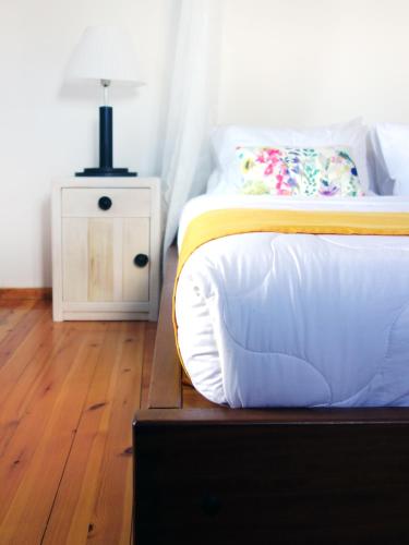 a bedroom with a bed and a lamp on a night stand at Villa Antonia in Almirida