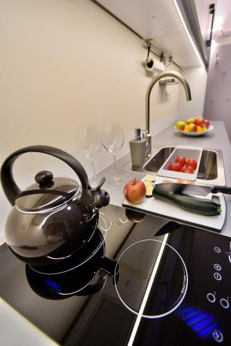 a tea kettle on top of a stove in a kitchen at Apartamenty Sjesta Centrum in Kudowa-Zdrój