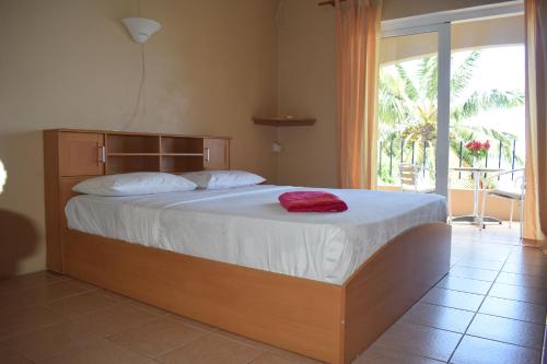 a bedroom with a large bed with a large window at Seaview Kite Studio - La Gaulette in La Gaulette