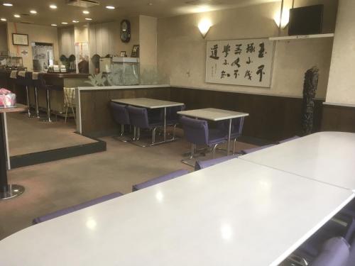 a restaurant with tables and chairs in a room at Hotel Tetora Kasugai Station Hotel in Kasugai