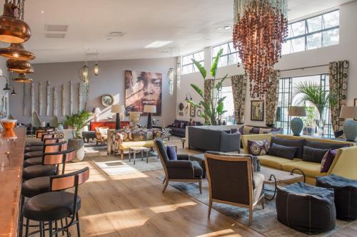 a lobby with couches and chairs and tables at Latitude 15 Degrees in Lusaka