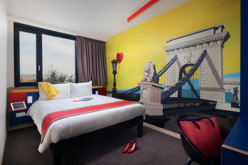 a hotel room with a bed and a fireplace at ibis Styles Budapest Citywest in Budapest