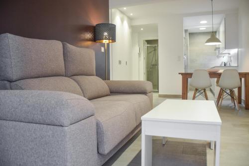 a living room with a couch and a table at Modern & spacious apartment near La Concha Bay in Donostia-San Sebastián