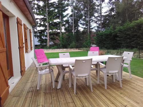 a white table and chairs on a deck at Gite Du Moulin Du Vivier in Seigy