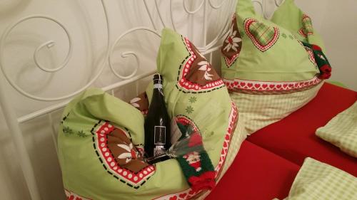 a woman in a green dress with a bottle of wine at Knusperhäuschen Maria Nikoletta in Witra