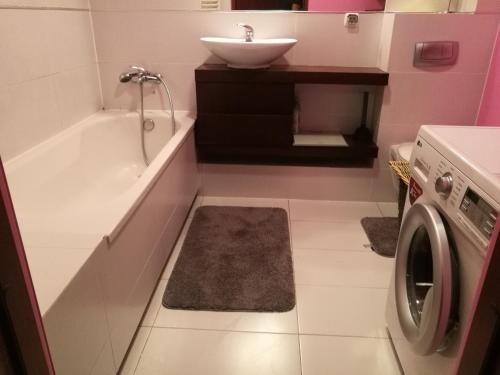 a bathroom with a sink and a washing machine at Salt Mine Apartment 64m2 in Wieliczka