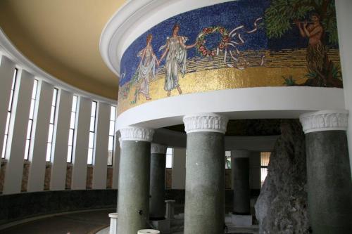 a hallway with columns and a painting on the ceiling at Amazing condo by the beach in Loutraki